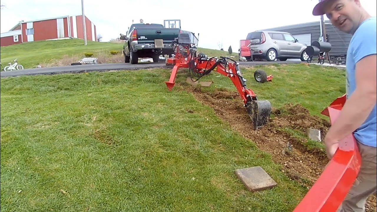 Beginner with towable backhoe digging for a sidewalk attached and