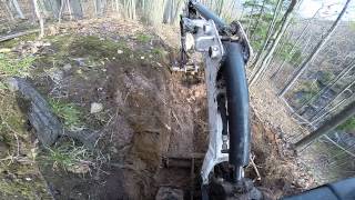 Bobcat 418 Singletrack. Trail construction on steep hill.