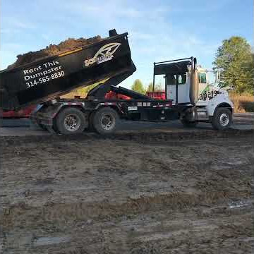 Hooklift picking up Heavy Mud