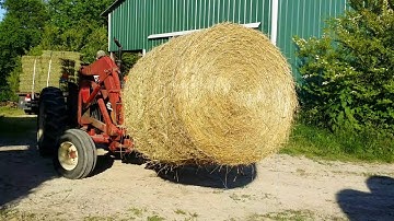 Unloading round bales from trailer - May 28, 2016