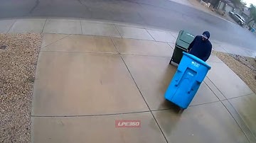 CCTV angle Guy watches trash cans float away
