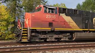 CN 2316, 2340 Westbound train with SSW, TOKAI  hoppers, MP gondola, BN hoppers at Vicksburg, MI