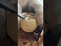 hand carving a traditional wooden spoon using sharp metal tools to create a beautiful smooth surface