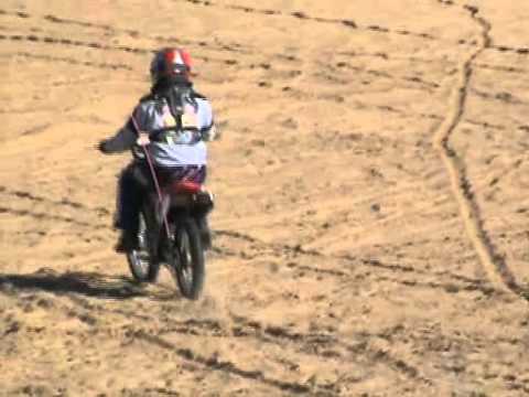 Jennifer riding her dirtbike near camp - Glamis Pr...