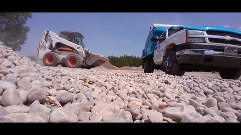 Loading the dump truck up with the Bobcat Skidsteer!