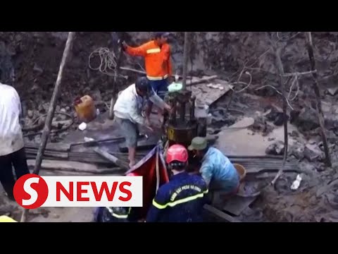 Rescuers in Vietnam try to save boy trapped in concrete pile