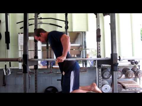 Extremely strong young man doing dips with a varie...