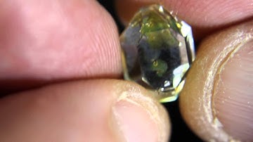 Moving bubbles in Quartz with Petroleum inclusions.
