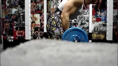 Michael Gundill performs Biceps curls (set 3) with elastic bands