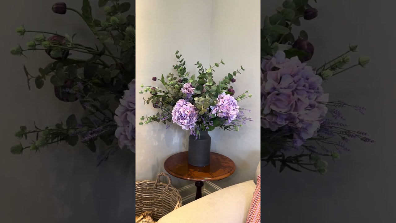 Purple faux hydrangea and foliage arrangement