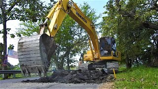 Komatsu PC210-10 MO Excavator Trucks Digging Bad Road Worn Asphalt