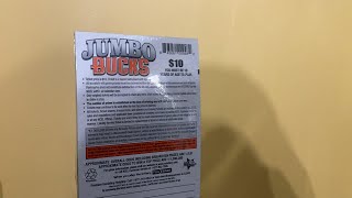 Scratching s full book of North Carolina Jumbo Bucks lottery tickets