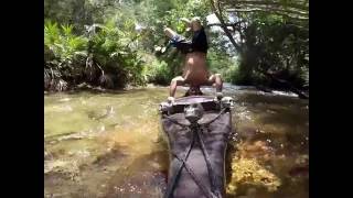 Doing headstand on a Paddle Board going down the rapids