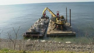 Lakeshore homeowner building steel wall to protect property from erosion