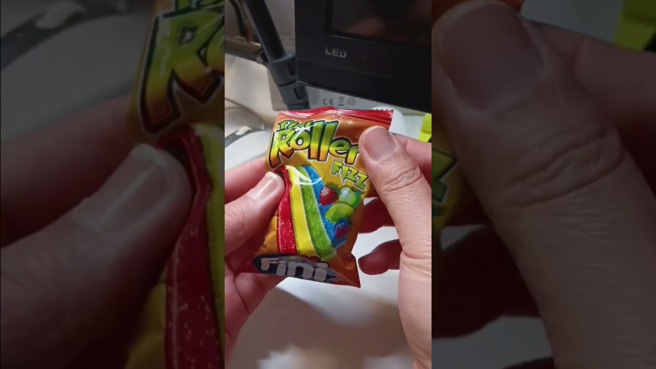 Unwrapping Roller Fizz candy 