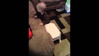 Baby Climbing Around On Furniture And Trying To Jump Off