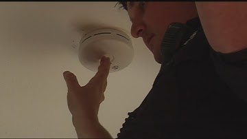 Red Cross volunteers and firefighters install smoke detectors for those in need