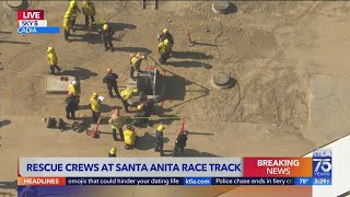 Firefighters work to free man from maintenance hole at Santa Anita Race Track