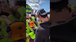 Lando Norris arrives in his Jaguar E type at Silverstone for British GP