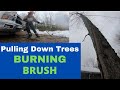 Pulling down Trees Burning Brush