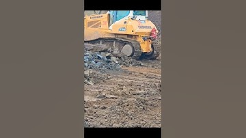 In dumpyard,the overburden dropped by the tipper is being further pushed by the dozer to form a berm
