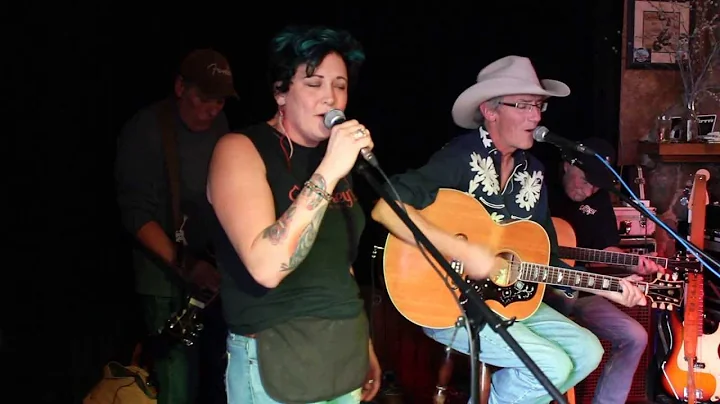 Sara Hammer and Tom Phillips sing "In spite of our...