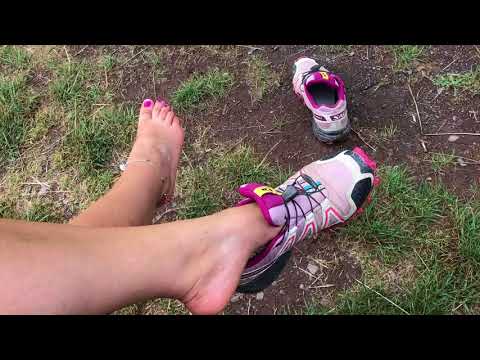 She is removing her Salomons outdoors