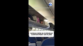 Woman seen in overhead compartment on plane