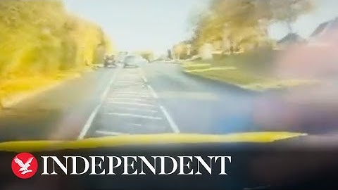 Moment driver speeds into oncoming traffic during police chase