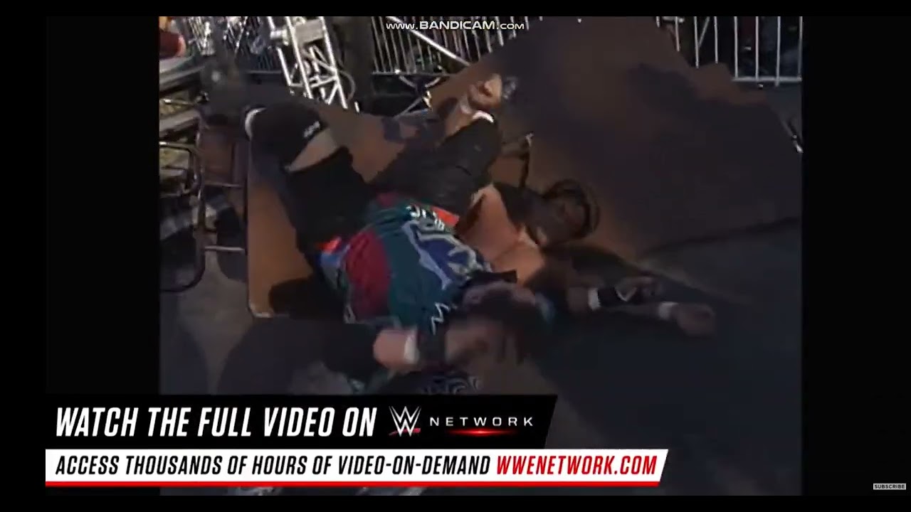 Rocco Rock elbow drops Disco Inferno through 3 stacked tables