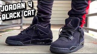 retro 4 black cat on feet