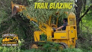 Finally doing some land clearing with the John Deere 350 loader.Making trails for the Kawasaki Teryx