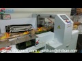 Box motion packing machine with top film roll