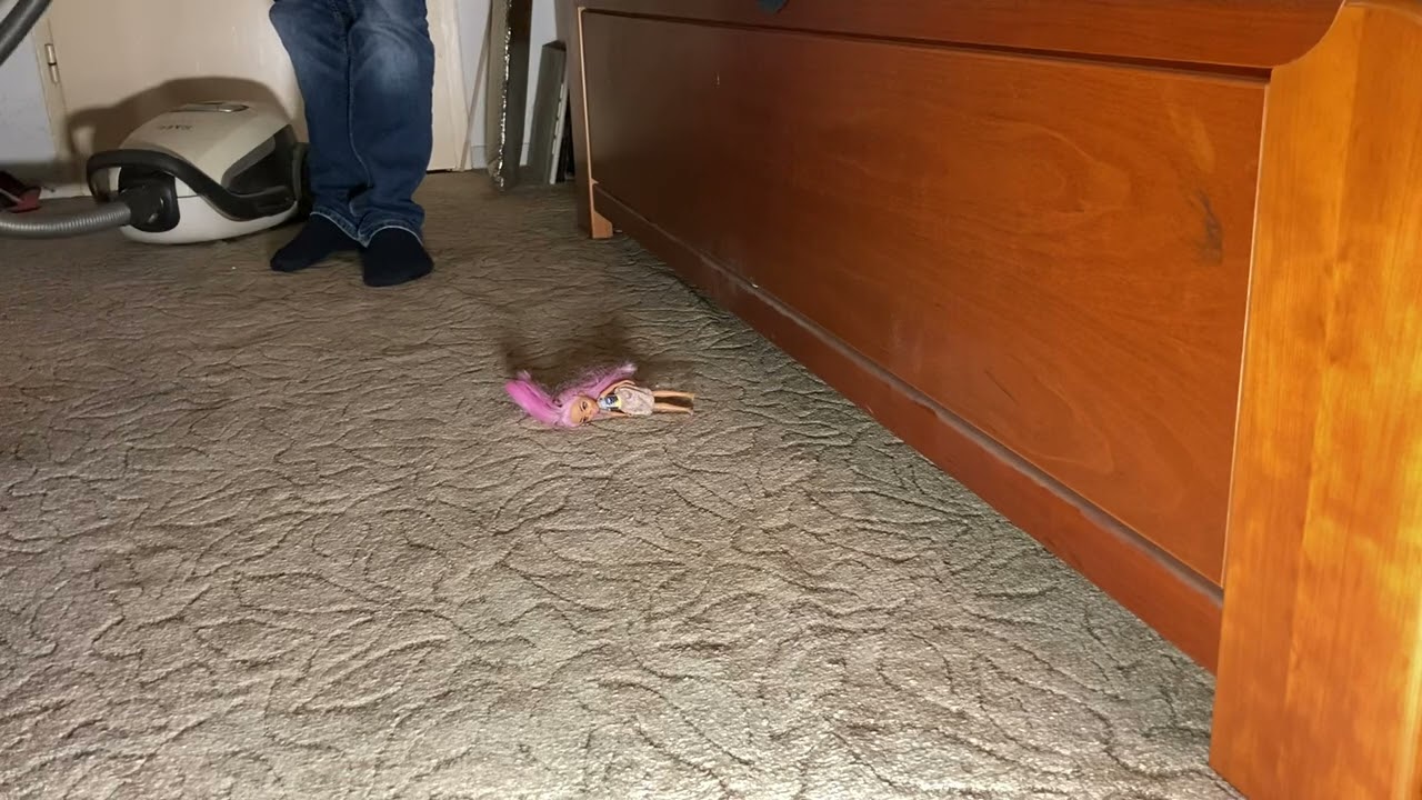 Vacuuming in the bedroom. There are toys lying around again.