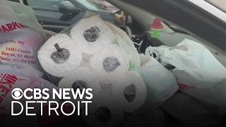 Detroit residents crowd grocery store for free grocery giveaway