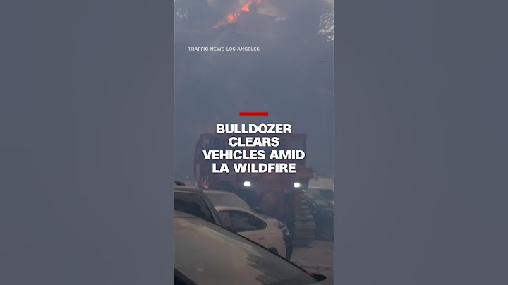Bulldozer clears vehicles amid LA wildfire