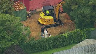 Excavator seen digging in backyard of man charged in Gilgo Beach killings