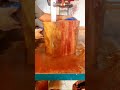 Cutting a large wooden log vertically using an industrial band saw for precise results #shorts