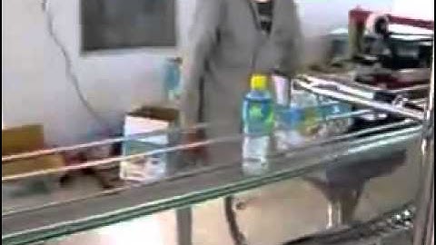 Dây chuyền rửa chiết rót đóng nắp co màng chai tự động