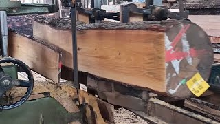 The process of cutting wood in a wood factory that uses a bandsaw machine to cut wood