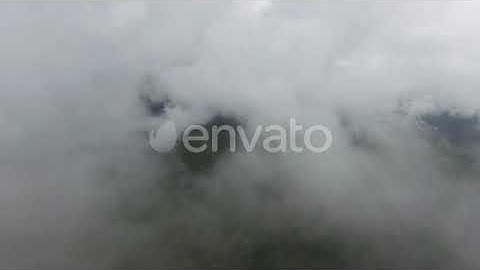 Flying Through Clouds Over Lake and Mountains | Stock Footage - Envato elements