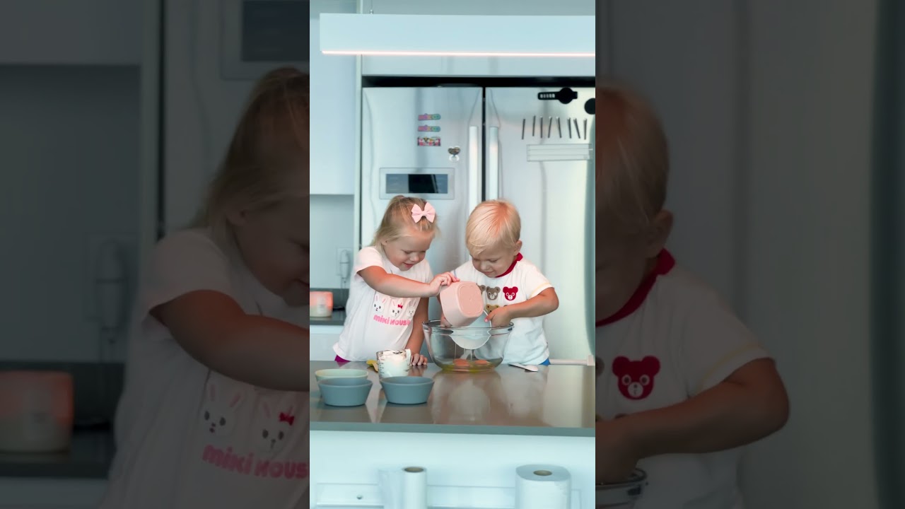 Children pour eggs into a large bowl. Cute Cooking Shorts!