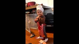 Toddler is cooking balls in toy kitchen