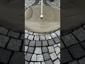 the process of evenly distributing the cement liquid on the black bricks in the building yard #short