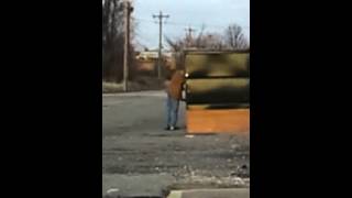 Man digging in dumpster