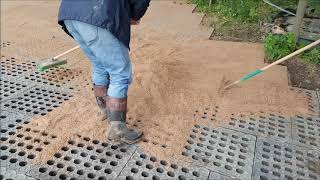 Laying Mudcontrol Slabs, Raking Sand Over To Fill The Holes And Help The Slabs Bed In Well.