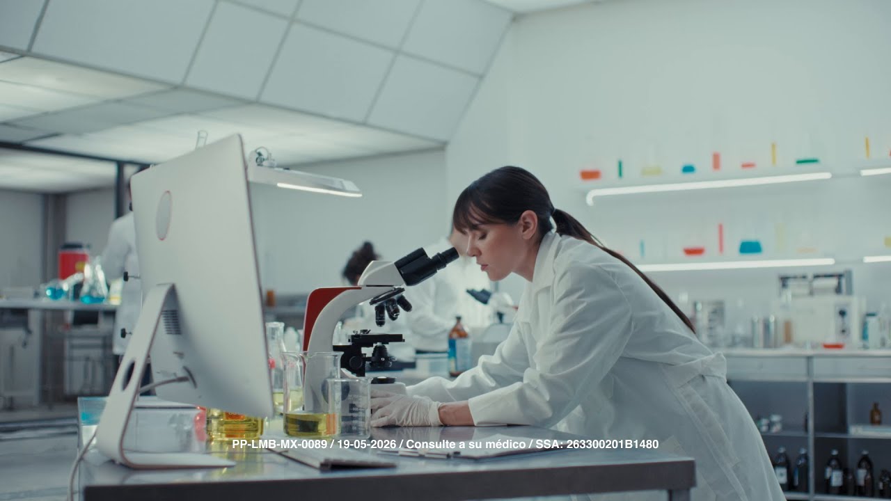 The ad opens in a sterile laboratory setting with scientists in white coats working with microscopes and beakers. The scene…