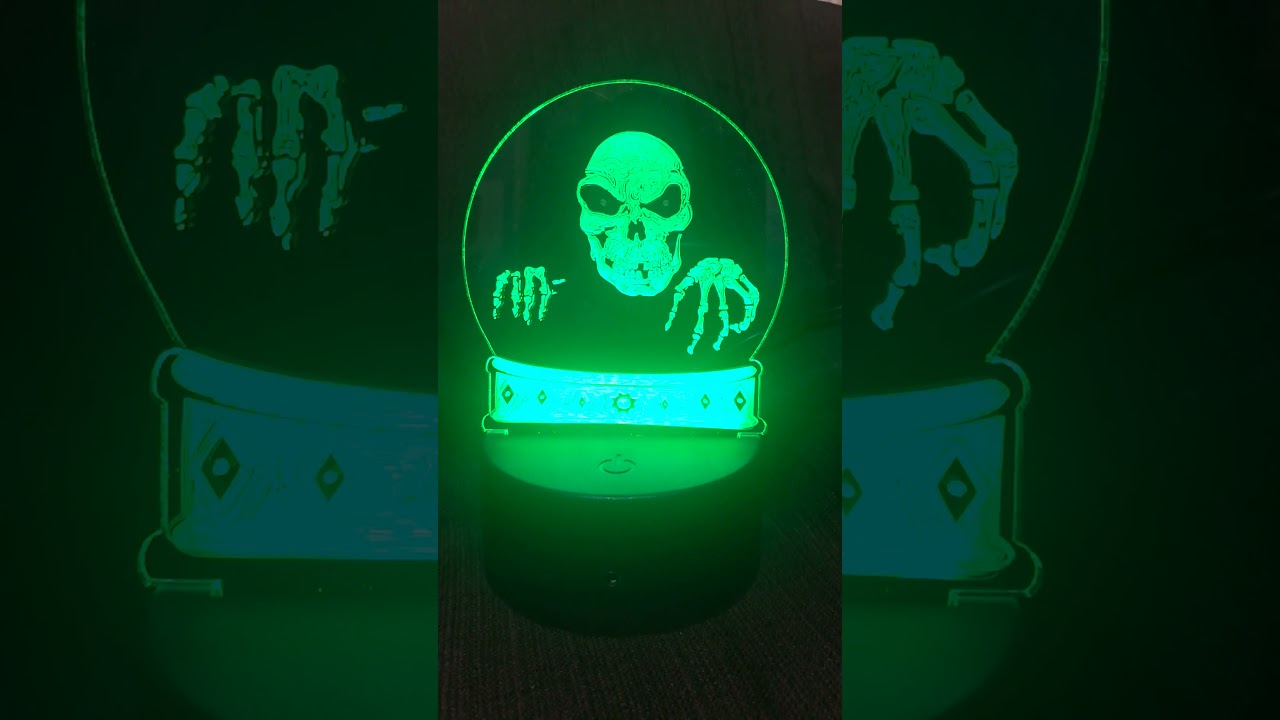 Spooky skull face in crystal ball LED light for Halloween