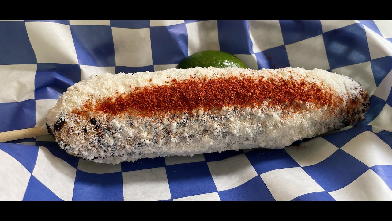 Powdery cheese on Grilled Corn Cuban Mexican styled Cotija Cheese
