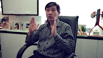 What is the key difference between laparoscopic and robotic-assisted surgery?